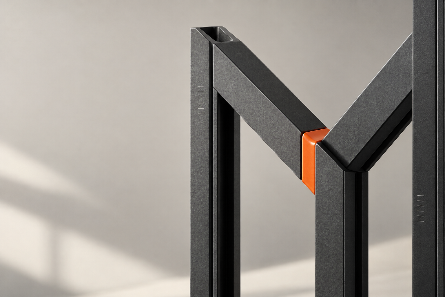 A graphite structural M with an orange connector